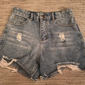 distressed high waste blue jean shorts.